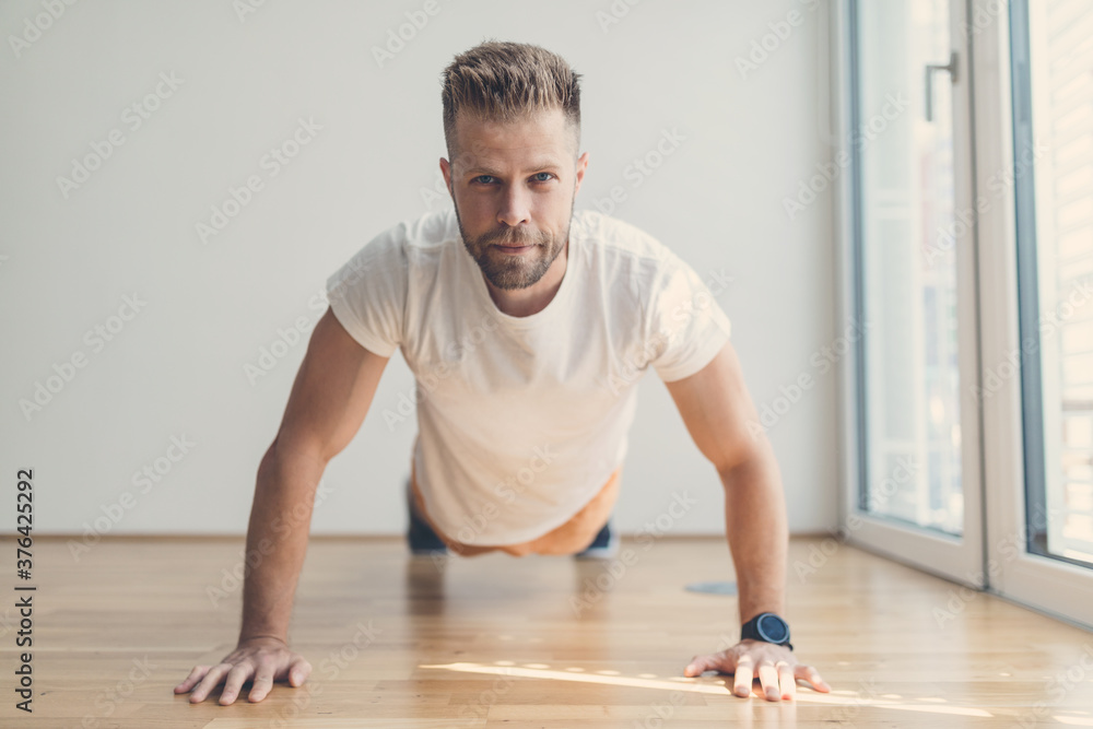 Handsome man working out at home Handsome man working out at home