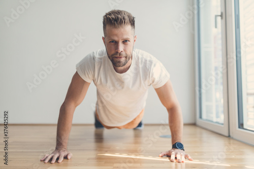 Handsome man working out at home
