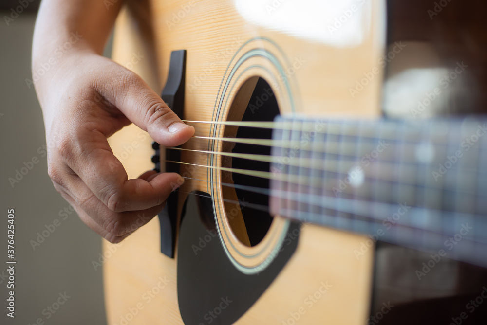 Fototapeta premium man playing acoustic guitar