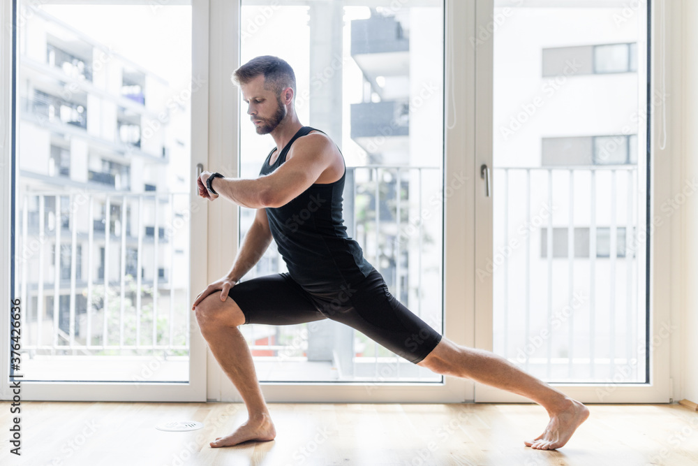Fototapeta premium Man practicing yoga at his home