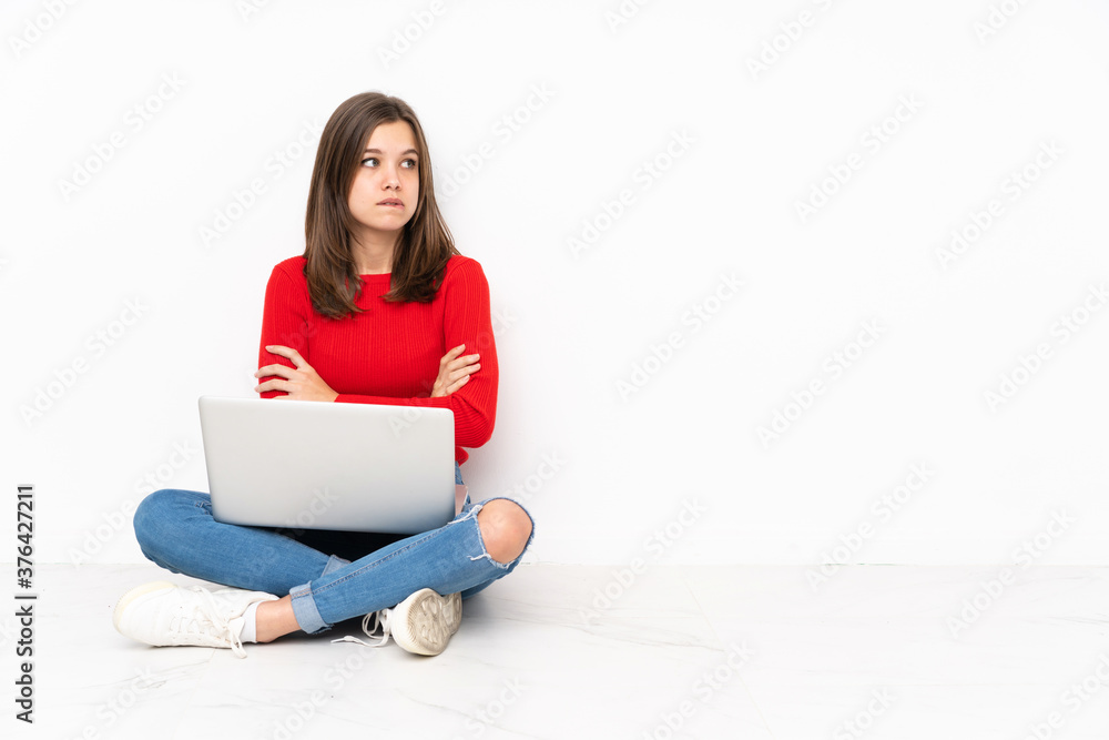 Tenaager girl working with pc isolated on white background with confuse face expression Tenaager girl working with pc isolated on white background with confuse face expression