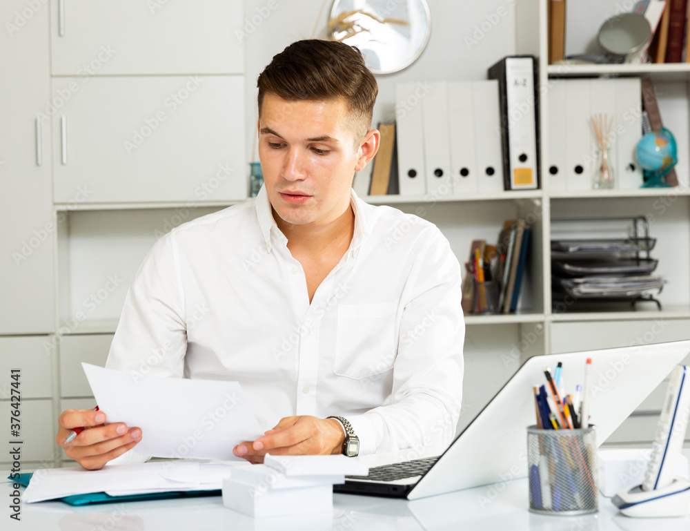 european guy in white shirt puzzled by problems in office european guy in white shirt puzzled by problems in office