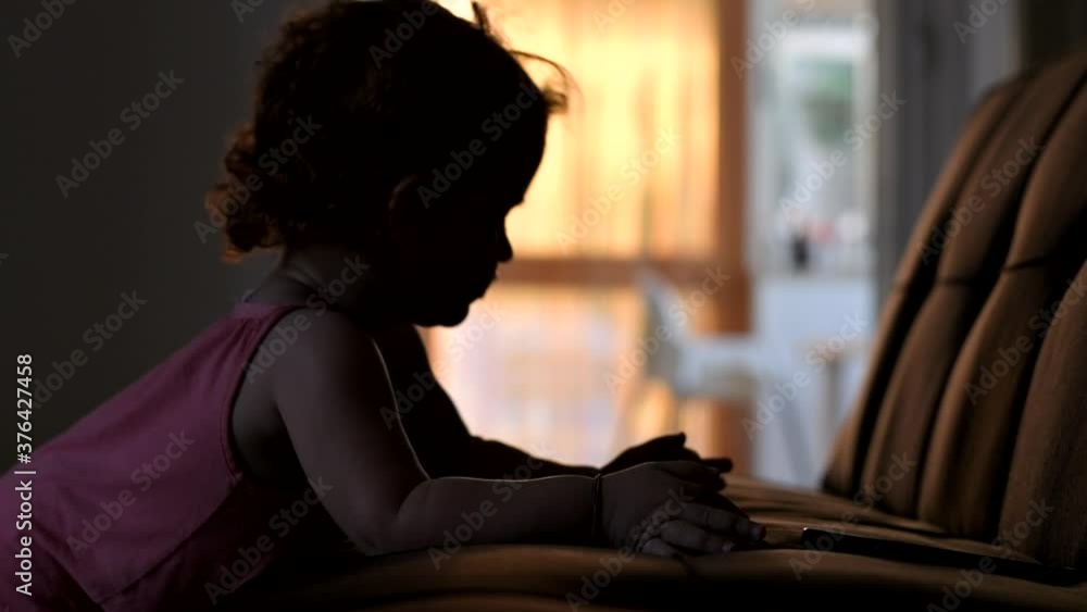 Cute baby girl playing with her smartphone in the house. Babies and technology Cute baby girl playing with her smartphone in the house. Babies and technology