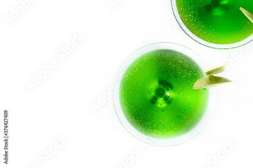 Green appletini cocktail in glass isolated on white background. Copy space