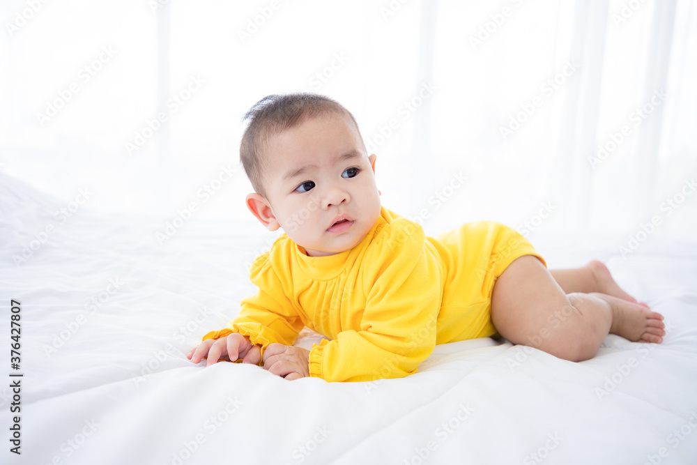 Happy excited infant baby girl crawling on the bed in the morning. Being a good child. Happy excited infant baby girl crawling on the bed in the morning. Being a good child.