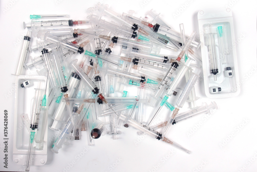 Pile of used medical syringes with needles Pile of used medical syringes with needles