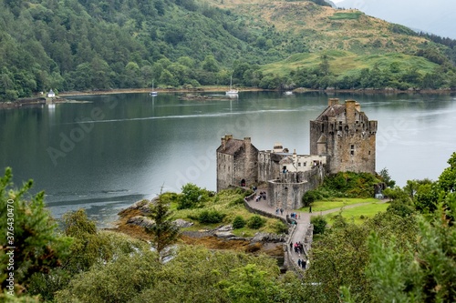 Eilean Donan Castle, Scotland, UK in waters of Loch Duich viewed from the top of hill above Dornie village