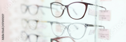 Fotografie On stand are glasses in beautiful frames. Optics salon concert