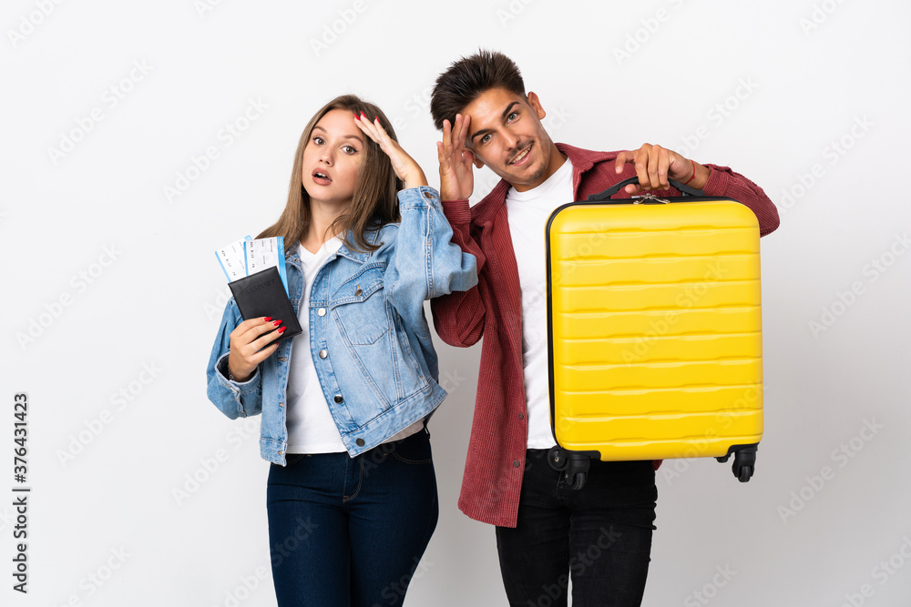 Traveler couple holding a suitcase isolated on blue background has just realized something and has intending the solution Traveler couple holding a suitcase isolated on blue background has just realized something and has intending the solution