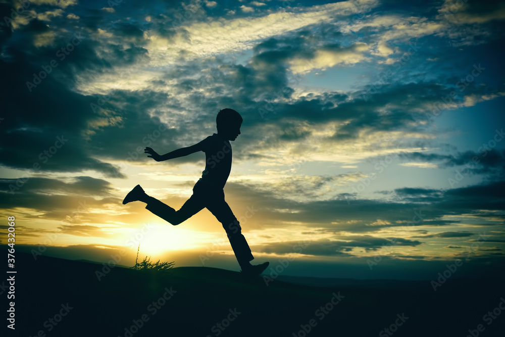 silhouette of a man jumping on the beach