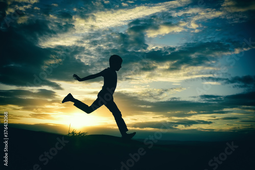 Fototapeta Naklejka Na Ścianę i Meble -  silhouette of a man jumping on the beach