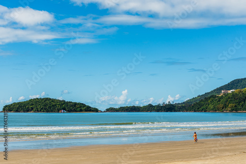 Fototapeta Naklejka Na Ścianę i Meble -  Strolling on beach shore in Brazil in a sunny summer day