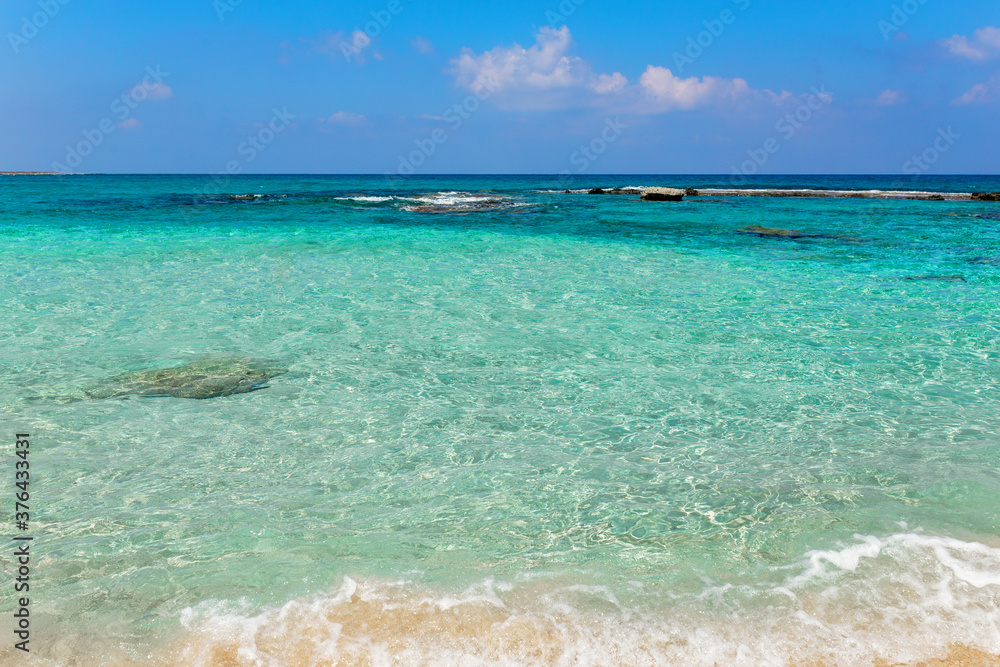 Fototapeta premium Beautiful beach with crystal clear blue waters against blue sky