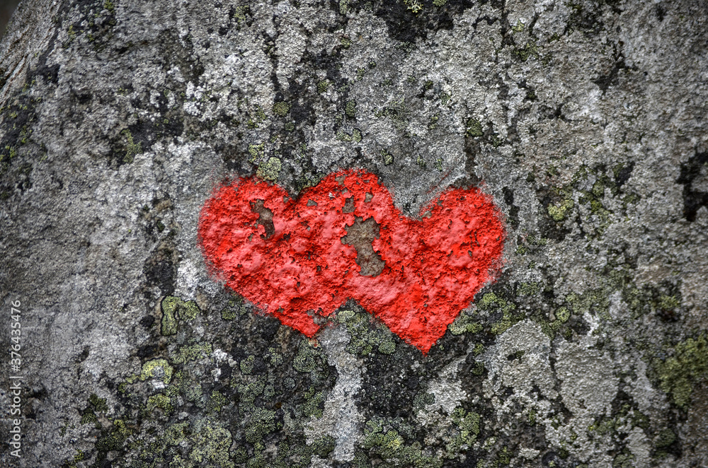 Two red hearts are painted in stone Two red hearts are painted in stone