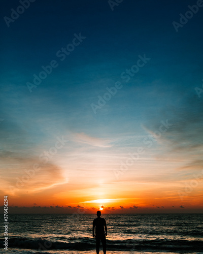 silhouette of a man on the beach at sunrise