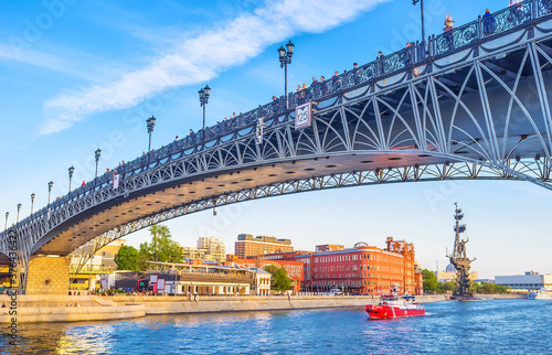 The view on the embankment of Moskva river with the Patriarshy Bridge and statue of Peter the Great on the background in Moscow, Russia