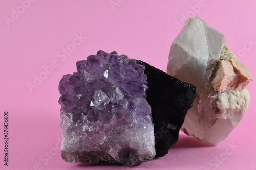 minerals and rocks placed on a pink background
 photo