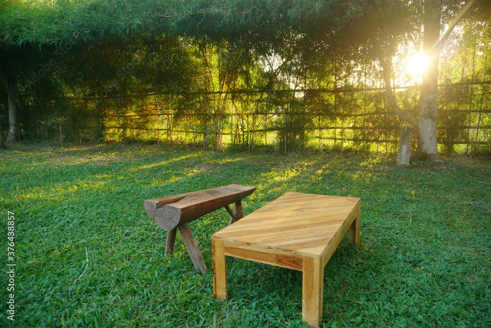 Wooden bench and table on a plain grass field. Wooden bench and table on a plain grass field.