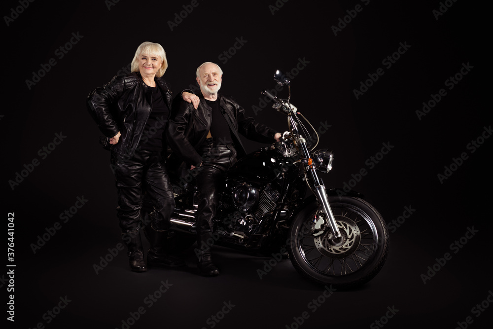 Portrait of his he her she nice attractive trendy fashionable cool cheerful cheery grey-haired couple chopper travelers enjoying way road voyage trip tour isolated over black color background