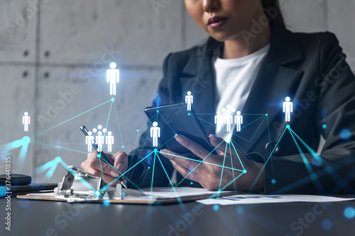 Businesswoman taking notes and social media icons hologram. Double exposure. Technology security network solution concept.