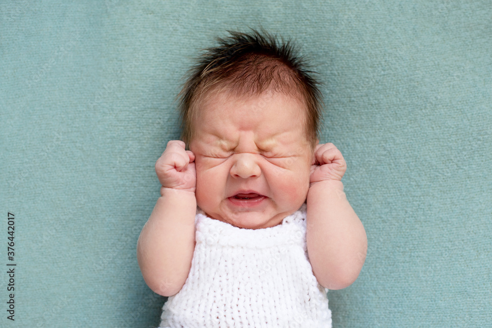 portrait of crying newborn baby. emotions of discontent. colic.  - obrazy, fototapety, plakaty 