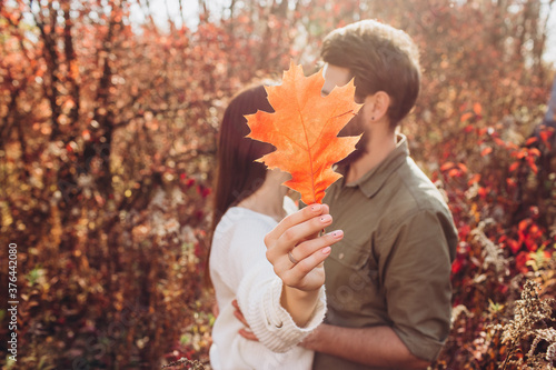 Portrait of a young couple in the autumn forest  a guy and a girl cuddling in the outdoor