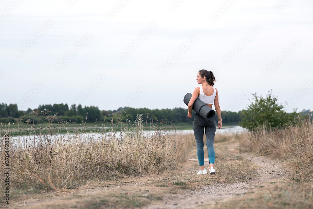 Young sporty woman doing fitness exercises near the river. Young sporty woman doing fitness exercises near the river.