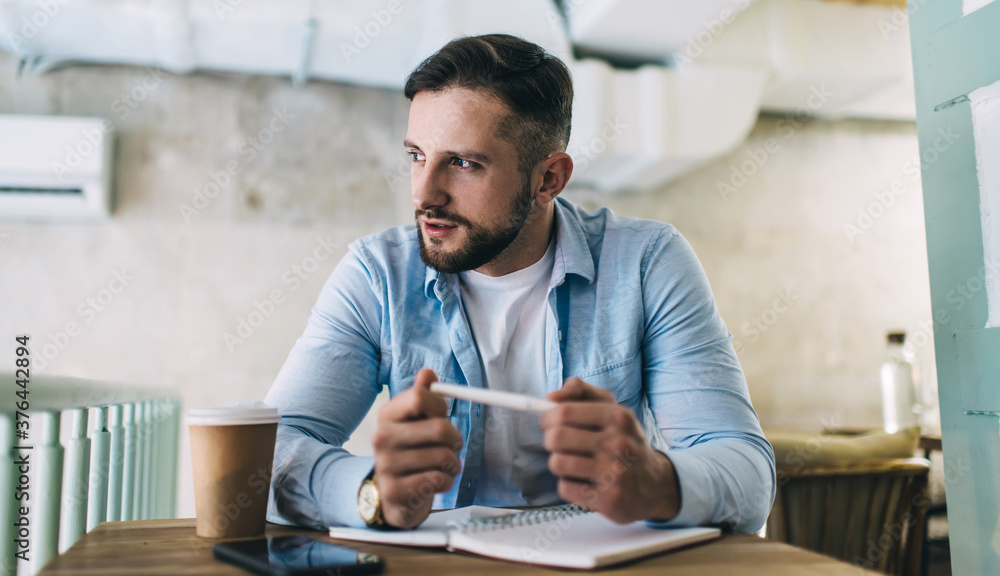 Smart man thinking about work while sitting in cafe Smart man thinking about work while sitting in cafe