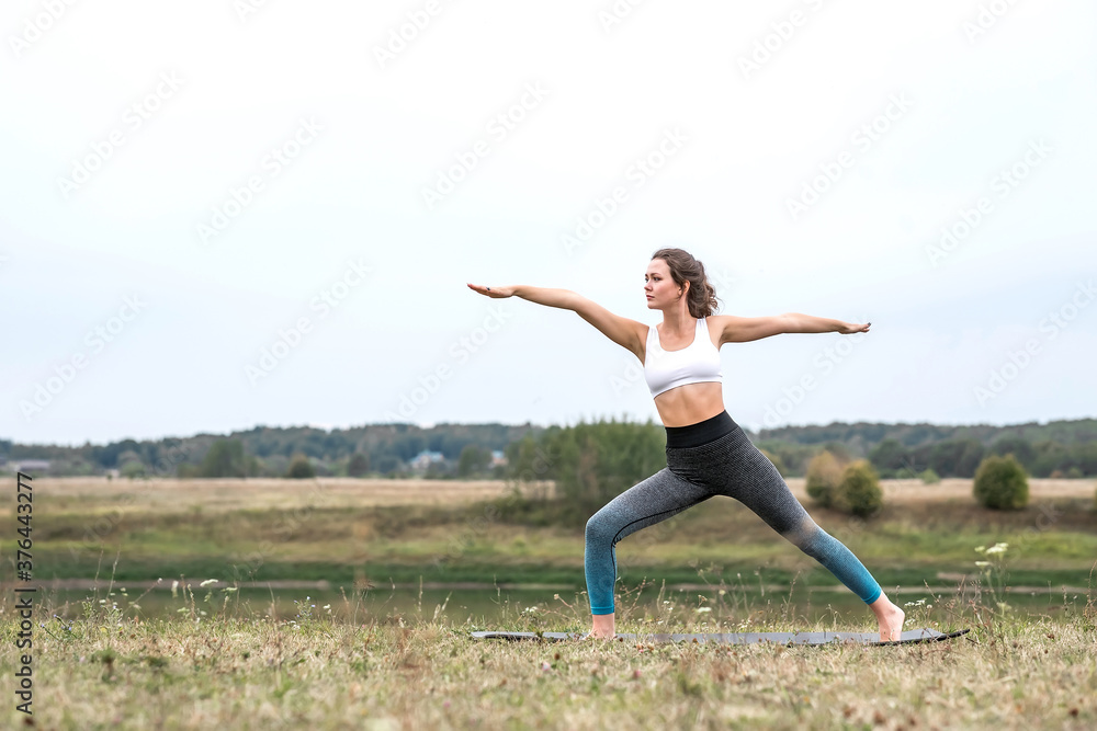 Young sporty woman doing fitness exercises near the river. Young sporty woman doing fitness exercises near the river.