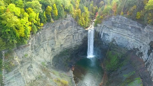 Aerial view of a waterfall in a canyon during early sunset in autumn in New York