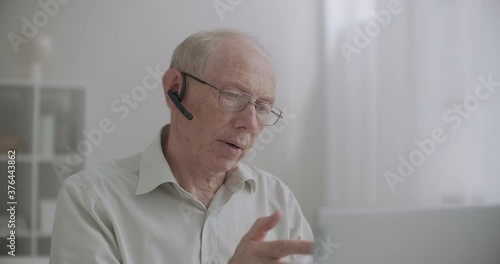 Wallpaper Mural elderly experienced engineer is consulting students online, videoconference and webinar technology by laptop Torontodigital.ca