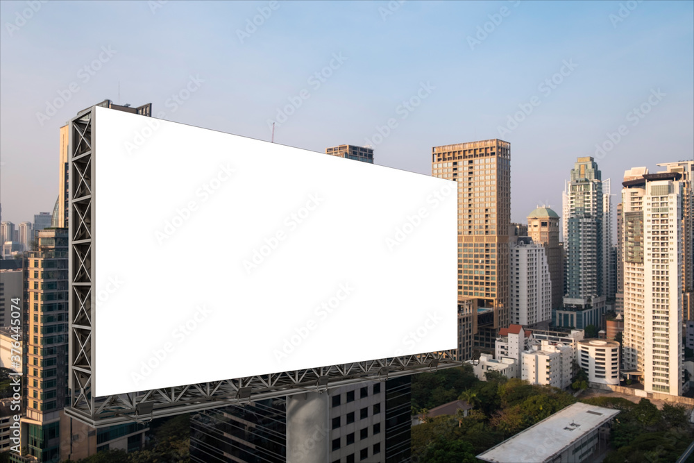 Blank white road billboard with Bangkok cityscape background at sunset. Street advertising poster, mock up, 3D rendering. Side view. The concept of marketing communication to promote or sell idea. Blank white road billboard with Bangkok cityscape background at sunset. Street advertising poster, mock up, 3D rendering. Side view. The concept of marketing communication to promote or sell idea.