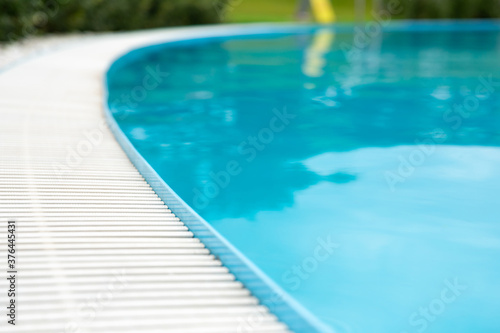 blue transparent pool water surface and white plastic side grating. For montage of your product.