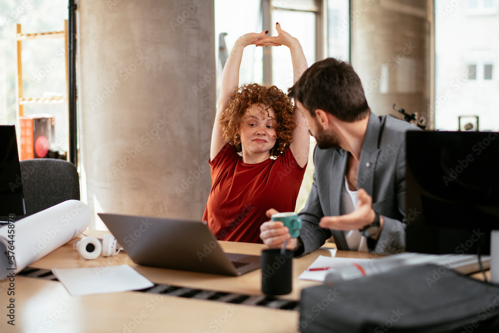 Businessman and businesswoman working on the project. Businessman explaining his new plan to his partner. Businessman and businesswoman working on the project. Businessman explaining his new plan to his partner.