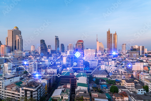 Glowing hologram of technological process, aerial panoramic cityscape of Bangkok at sunset. The largest innovative hub of tech services in Asia. Multi exposure. © VideoFlow