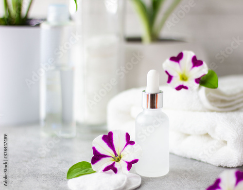 Natural cosmetic product for face and body care in a glass bottle. In the bathroom. Moisturizing and lifting. Smoothing out wrinkles and skin tone. The concept of home care.