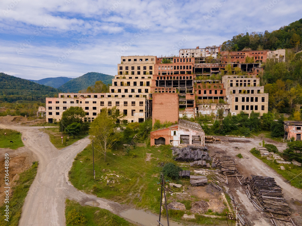 View from above. Ruined and abandoned buildings of a tin mining factory in the village of Kavalerovo. Khrustalnensky ore mining and processing plant