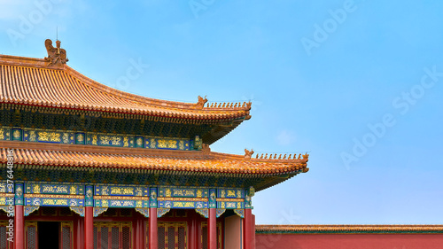 traditional Chinese roofs with figurines on the blue sky background. The Imperial Palace in Beijing
