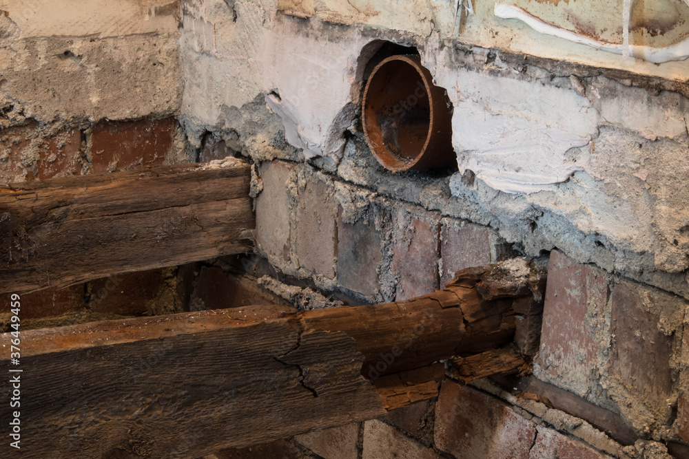 Rotton broken floor joists exposed during home renovation and building works.