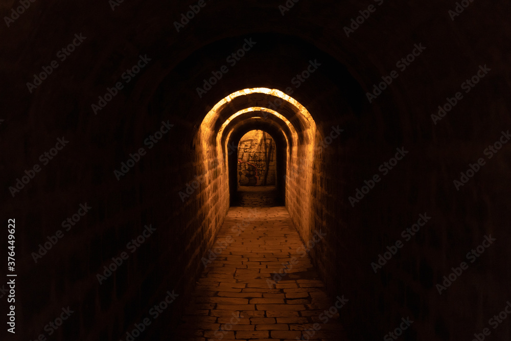 
old stones illuminated by a tunnel at a castle in the Czech Republic at night