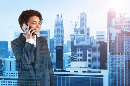 Successful smiling black African American business woman in suit pensively talking phone, Singapore cityscape. The concept of consultants as problem solvers. Investment fund. Double exposure.