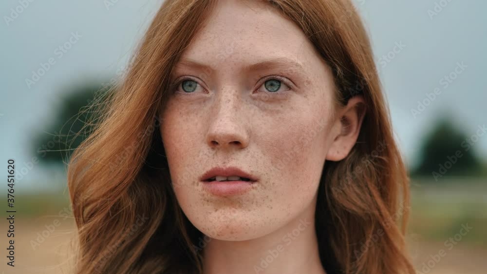 Portrait of Woman’s Face, Girl opening her Beautiful blue Eyes, Attractive Ginger. Natural Beauty with Freckles. Slow motion. Red-Haired Woman enjoying Fresh Air, feeling Liberty at Countryside. Portrait of Woman’s Face, Girl opening her Beautiful blue Eyes, Attractive Ginger. Natural Beauty with Freckles. Slow motion. Red-Haired Woman enjoying Fresh Air, feeling Liberty at Countryside.