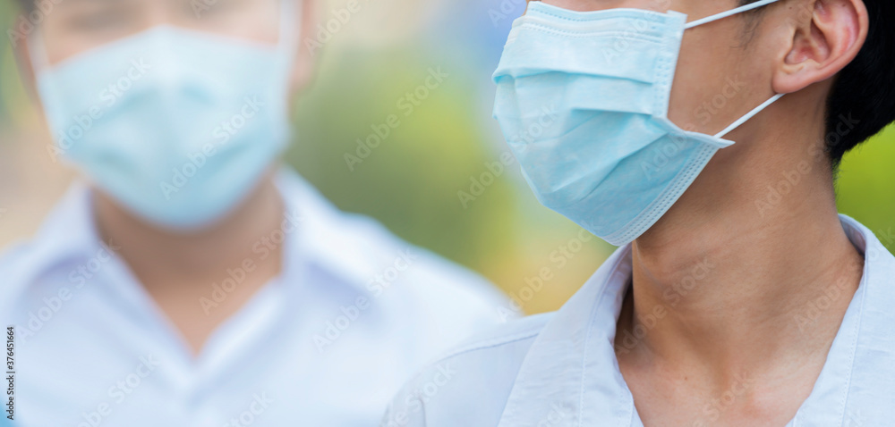 Cropped view of Two man wearing facial hygienic mask for Safety outdoor against infectious diseases, covid19, flu, anti-pollution, anti-smog and viruses. Selective focus Cropped view of Two man wearing facial hygienic mask for Safety outdoor against infectious diseases, covid19, flu, anti-pollution, anti-smog and viruses. Selective focus