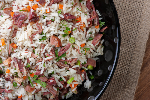 Arroz de Carreteiro - Typical food from southern Brazil, made with rice, dried meat, pepperoni sausage, bacon and carrots. Top view photo