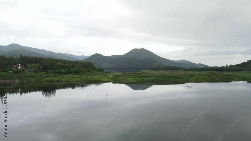 Mountain lake with turquoise water and green trees. Reflection in the water. Beautiful spring landscape with mountains, forest and lake. Aerial View. Drone shot over a beautiful mountain forest lake Mountain lake with turquoise water and green trees. Reflection in the water. Beautiful spring landscape with mountains, forest and lake. Aerial View. Drone shot over a beautiful mountain forest lake