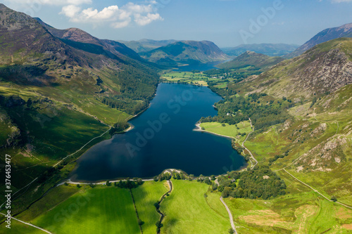 Aerial view of a beautiful lake in a narrow valley surrounded by tall mountains  Buttermere 