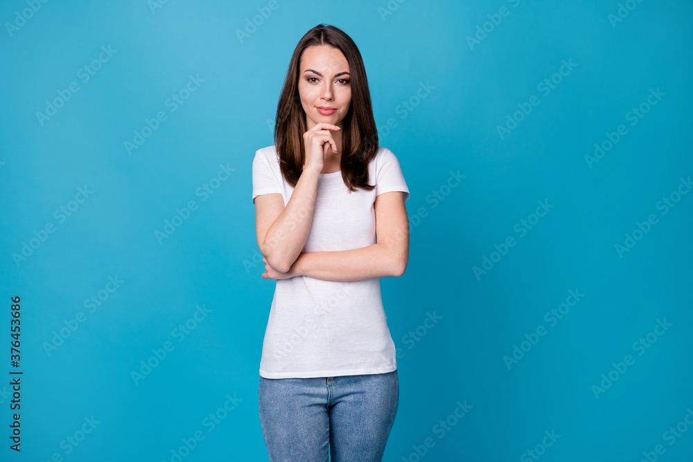 Photo of attractive charming lady hold arm on chin look flirty tricky on camera think sly eyes creative intelligent person wear casual white t-shirt jeans isolated blue color background Photo of attractive charming lady hold arm on chin look flirty tricky on camera think sly eyes creative intelligent person wear casual white t-shirt jeans isolated blue color background