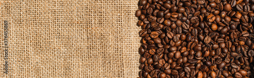 top view of roasted coffee beans on sackcloth  panoramic shot