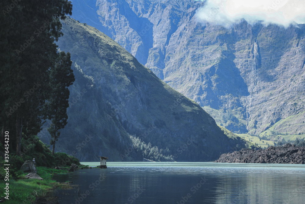 Blue Lake Segara Anak with green cliffs background