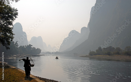 A hazy scene along the Li River between Guilin and Yangshuo in Guangxi Province, China. The karst hills and river scenery have provided inspiration for artists and poets. Li River scenery, Guilin.